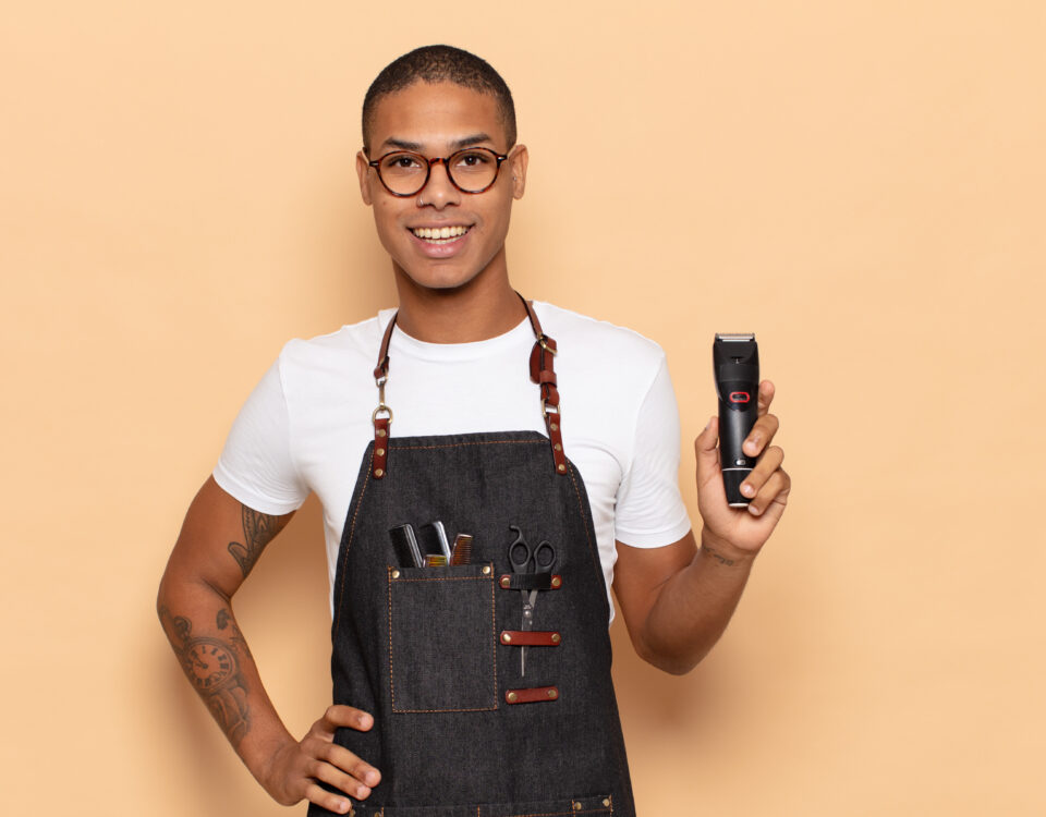 jovem negro sorrindo feliz com a mao no quadril e uma atitude confiante positiva orgulhosa e amigavel